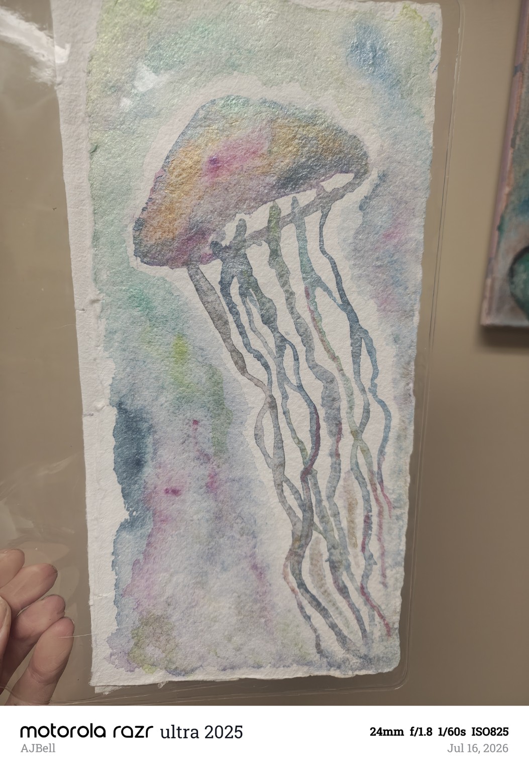 A translucent jellyfish with long flowing tentacles in pale blue, violet and rose washes