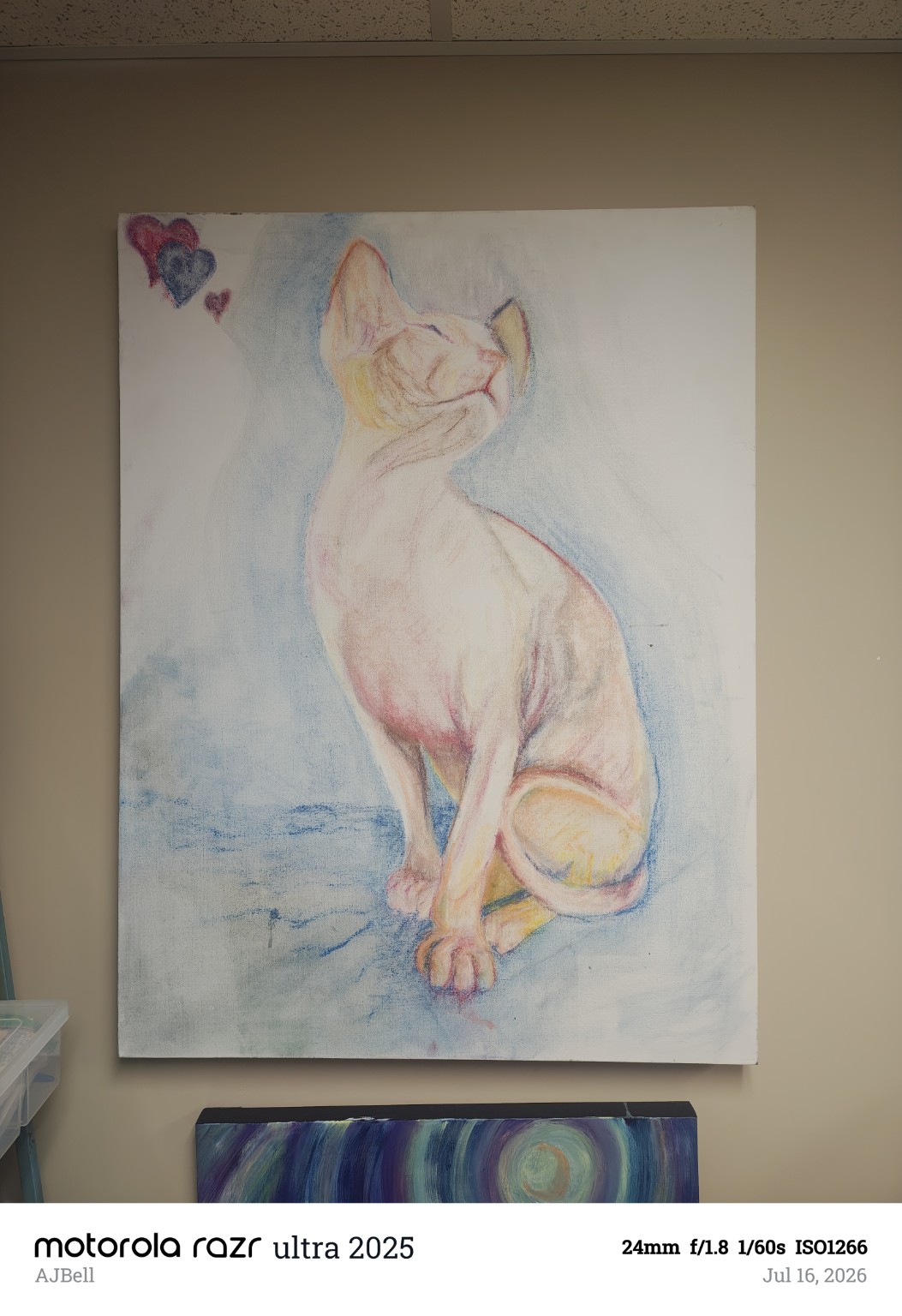 A seated hairless cat in pale pink and yellow with blue shading and small hearts above