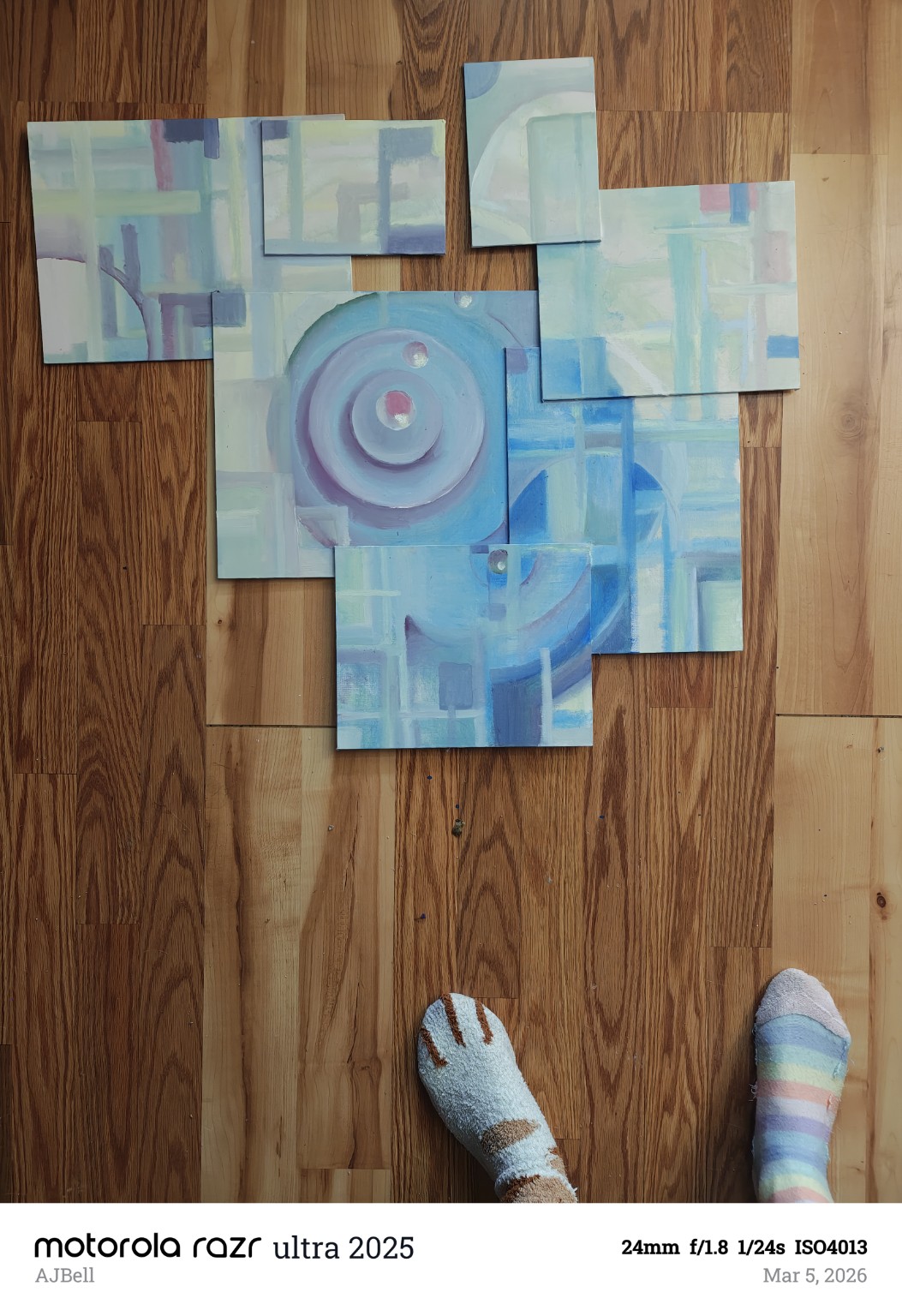 An arrangement of painted panels with pastel geometric shapes and concentric blue circles